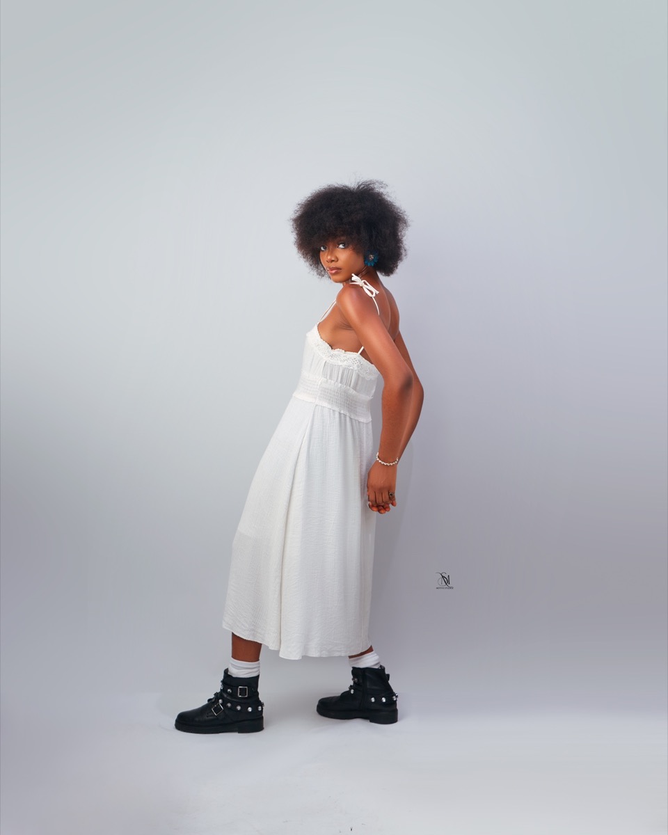 Full length studio portrait in a white dress