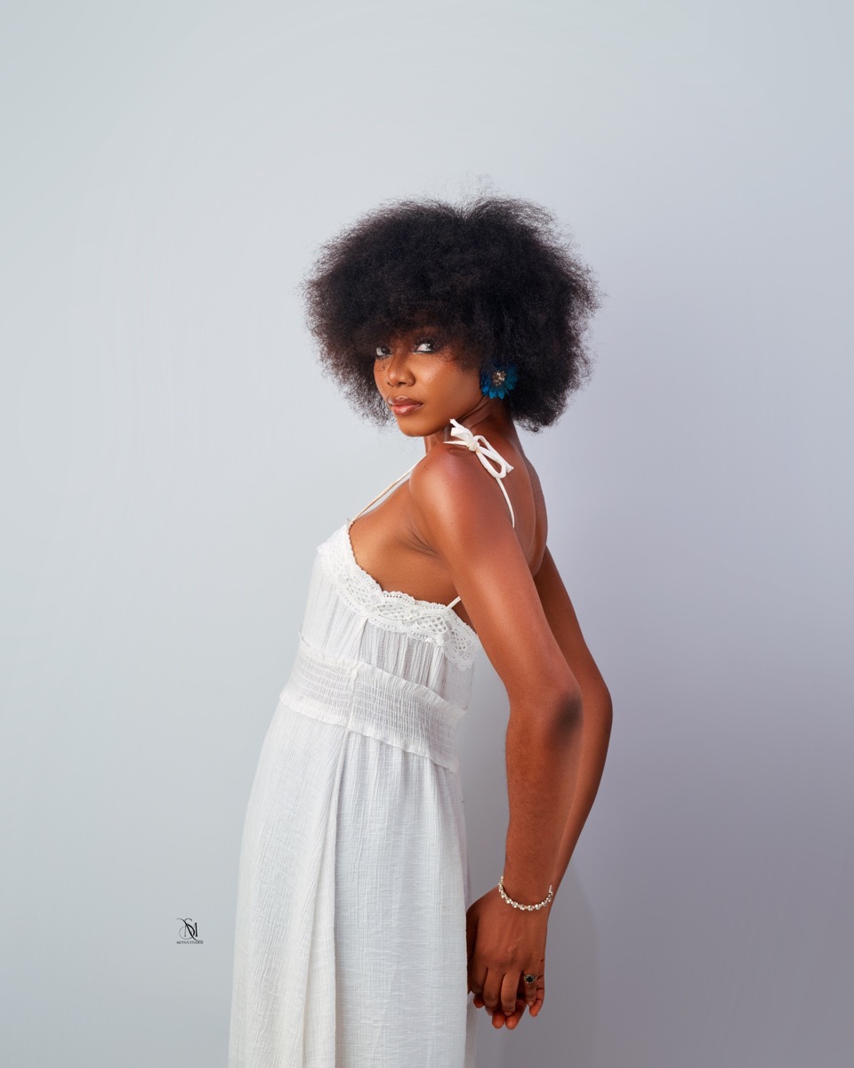 Profile studio portrait in a white dress